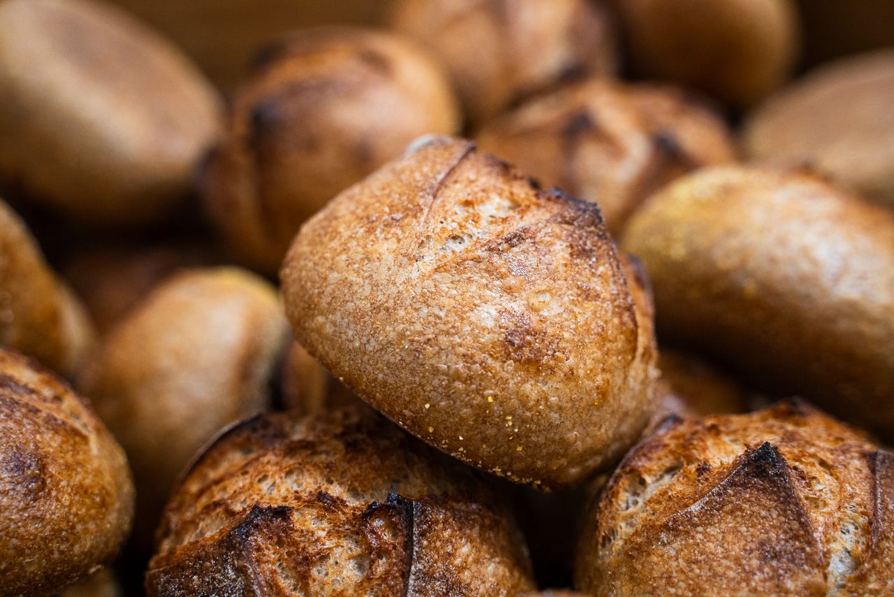 Warm and inviting close-up of artisanal bread rolls in a bakery display in Berlin.